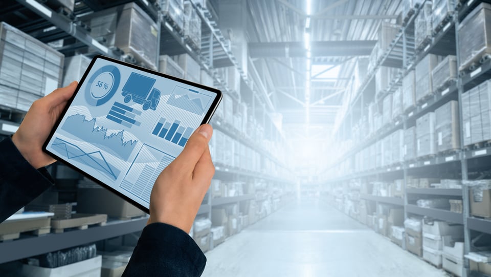 Procurement specialist checks data on tablet to get real-time supply chain analytics.